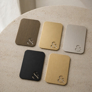 Five metallic swatch colours with ampersand design on a beige surface