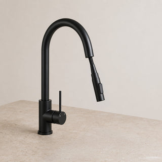 Black kitchen tap on a beige countertop with a neutral background