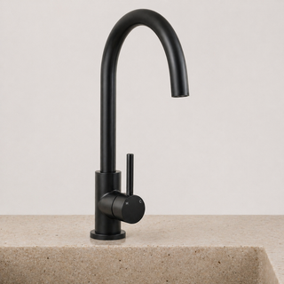 Black kitchen faucet on a beige countertop with a light gray background