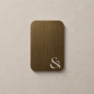 antique brass swatch colour with a white ampersand on a beige background