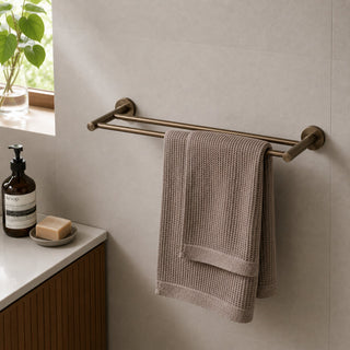 antique brass double towel rail in a modern bathroom with a timber vanity and beige tiles