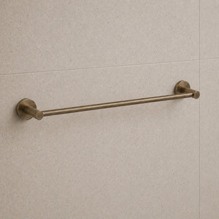 antique brass towel bar mounted on a beige tiled wall