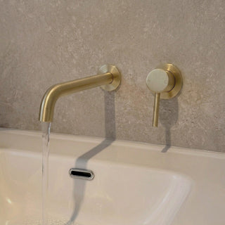 Reno brushed brass wall spout tap close-up showing spout detail