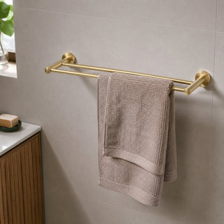 brushed brass double towel rail in a modern bathroom with a timber vanity and beige tiles