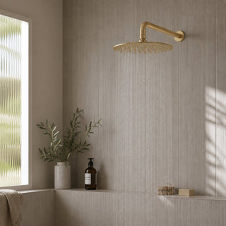 brushed brass shower head in a modern bathroom