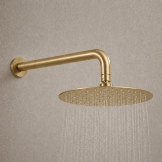 brushed brass shower head with water on