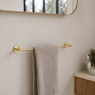 brushed brass single towel rail in a bathroom with beige tiles and a timber vanity