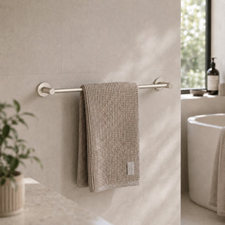 brushed nickel towel rail in a modern bathroom with a timber vanity and beige tiles