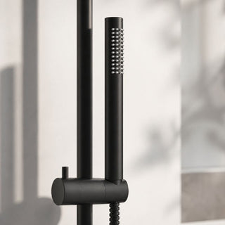 Black shower head and handle set against a neutral background