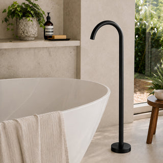 matt black free standing bath tap in a modern bathroom with beige tiles and a free standing bath