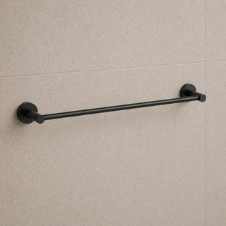 Black towel bar mounted on a beige tiled wall