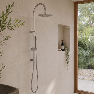 Shower system mounted on a tiled wall with a window showing greenery outside.
