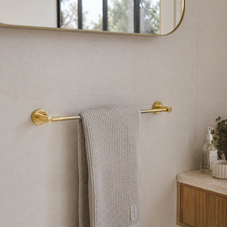 polished gold towel rail in a modern bathroom with a timber vanity and beige tiles