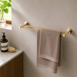 polished gold towel rail in a modern bathroom with beige tiles and a timber vanity