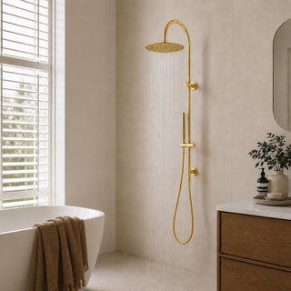 polished gold gooseneck rain shower head set in a modern bathroom with beige tiles and an indoor plant
